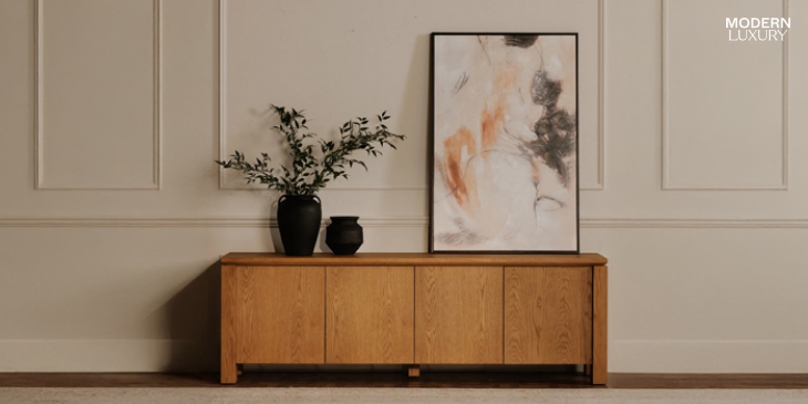Brook Country Oak media unit with a modern framed abstract painting and decorative vases in a minimalist living room setting.