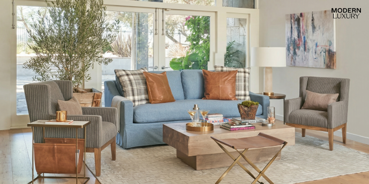 Harper Scissor Ottoman in Tanned Umber and Antique Brass, perfect for adding a touch of elegance to your living room in Houston.